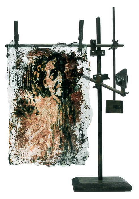 mixed media with a photographic image of an older woman, rust, carbon, an acrylic, hung on a found object (a quick-sketch)