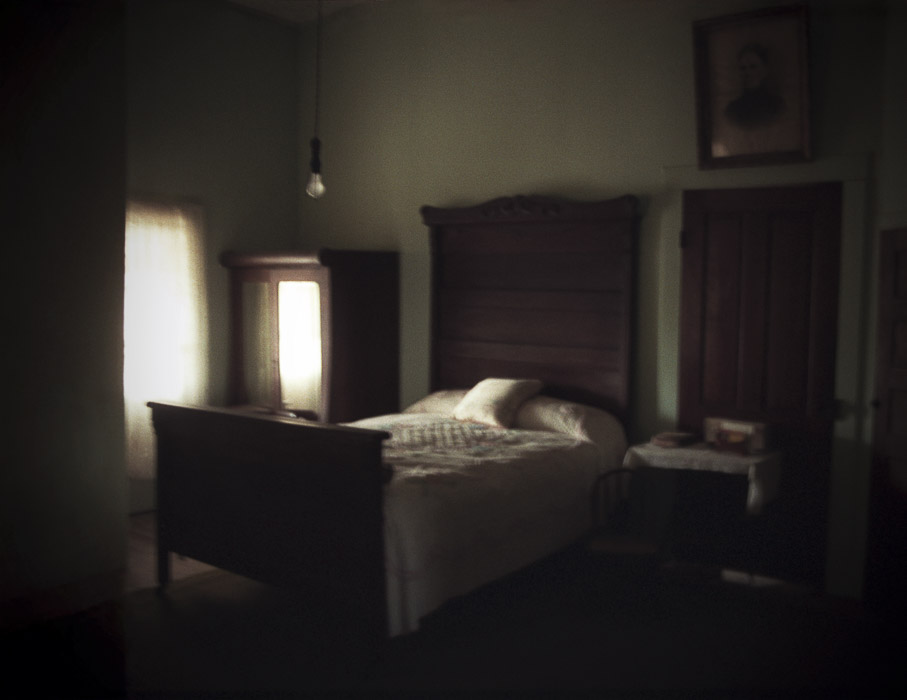 bed in old house with light from window