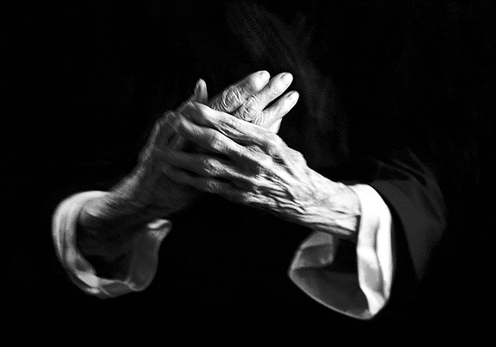 old hands, crossed, holding, blurred, black and white