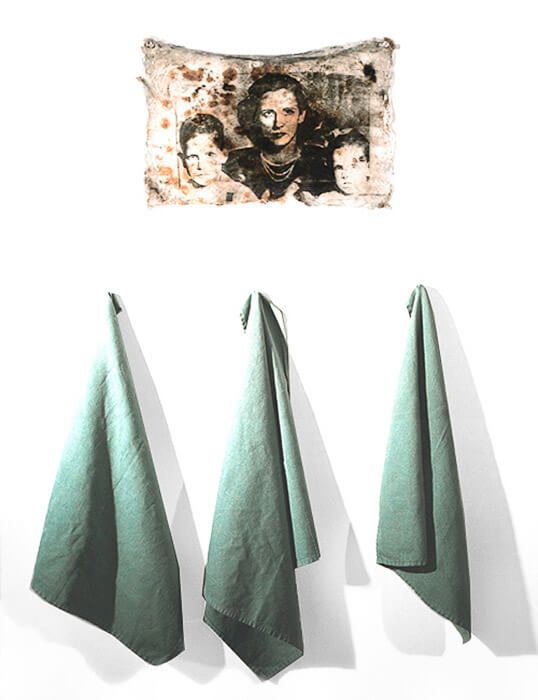 mixed media art, photographic image of a mother and children transferred to an acrylic skin with embedded rust and carbon, 3 napkins hang below