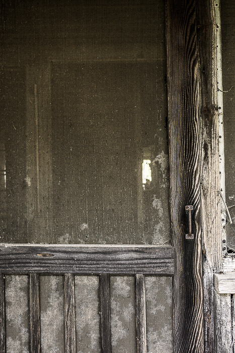 weathered screen door, dilapidate old house