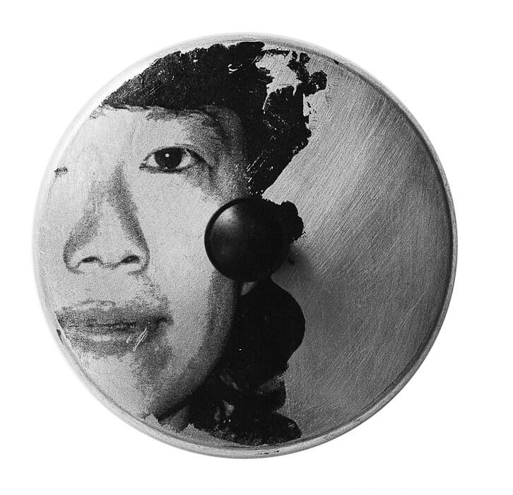 image transfer, face of a woman on a pot lid with a scratched surfaced