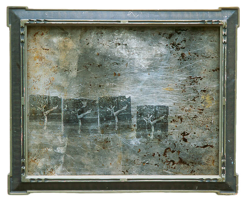 repeated images of a person kicking high transferred to a found object (scratched, stained pan) and in a old found frame