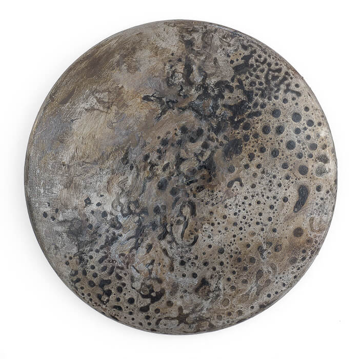 artwork, a burnt charred round metal found object, acrylic, charcoal