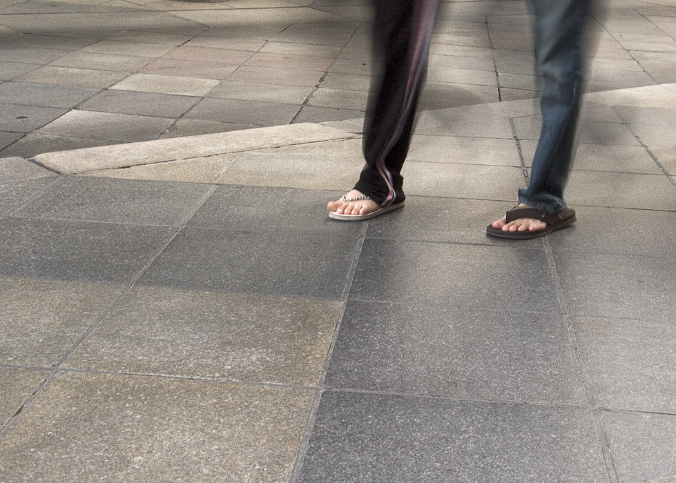 feet of two people walking, motion blur