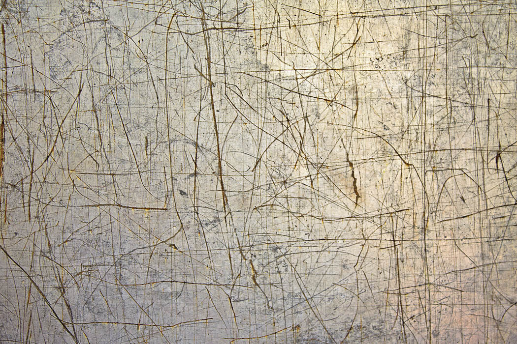 pan surface with lots of scratches, photograph